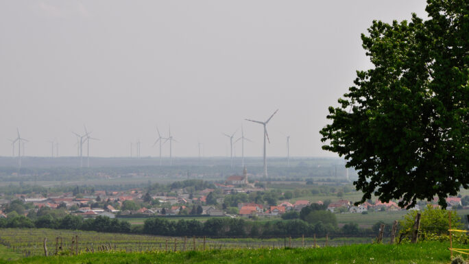 Blick auf die Gemeinde Höflein mit Windrädern im Hintergrund